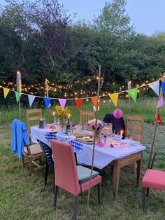 a table set up for a party with bunting and flags