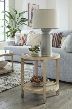 a living room filled with furniture and a lamp on top of a coffee table in front of a couch