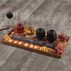 a tray with wine glasses and crackers on it