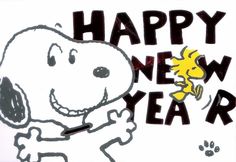 a happy new year sign with a cartoon dog and snoopy holding a yellow bird