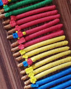 many different colored pieces of paper sitting next to each other on top of a wooden table