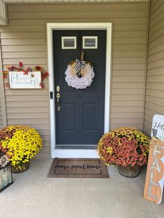 front porch decorated for fall with wreaths and flowers