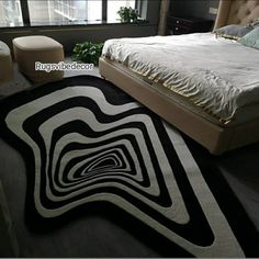 a bed room with a neatly made bed and a rug on the floor next to it