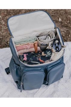 an open suitcase sitting on top of a blanket