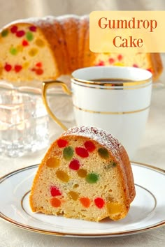 a slice of gumdrop cake on a plate with a cup and saucer in the background