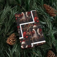 a christmas wrapping paper on top of pine cones