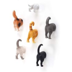 six small plastic cats standing in a row