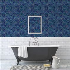 a bath tub sitting under a mirror next to a tiled wall