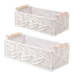 two white baskets with bamboo handles