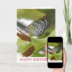 a hand holding a cell phone with a birthday card on it