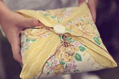 a boy is holding a gift wrapped in yellow paper and smiling at the camera while another photo has been taken