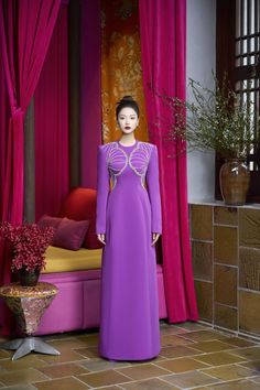 Indulge in the luxurious sophistication of our Ao Dai. The shimmering velvet and satin fabrics create a luminous effect, while the A-line cut and floor length silhouette offer a flattering and elegant look. Experience the beauty and grace of this exquisite piece. Length: 150cm (Ao Dai), 110cm (Pants) Elegant Purple A-line Gown, Luxury Floor-length Evening Dress For Festive Occasions, Luxury Festive Maxi Dress For Gala, Luxury Fitted A-line Gown, Elegant Festive Gown With Long Train, Purple A-line Evening Dress For Formal Occasions, Festive Elegant Gown With Long Train, Luxury Velvet Floor-length Dress, Luxury Purple Floor-length Gown