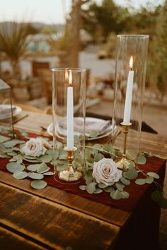 the table is set with candles and flowers