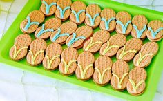 a green tray topped with cookies covered in frosting