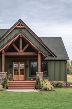 the front view of a house with green siding and stone steps leading up to it