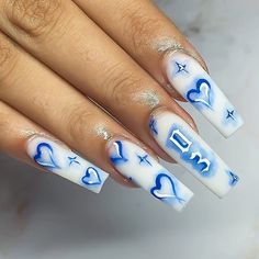 a woman's nails with blue and white designs on them, which reads what i asked for