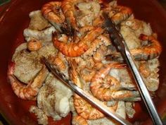 a bowl filled with cooked shrimp and meat