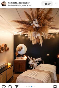 a room with a bed, mirror and lights on the ceiling is decorated with feathers