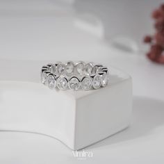 a diamond ring sits on top of a white box