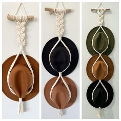 four hats hanging on the wall with ropes attached to each one and two different colors