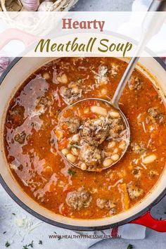 hearty meatball soup in a pot with a ladle