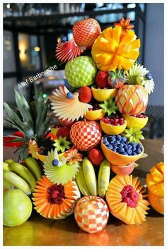 an arrangement of fruit is displayed on a table