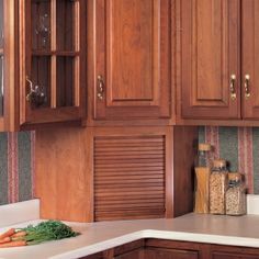 a kitchen with wooden cabinets and white counter tops