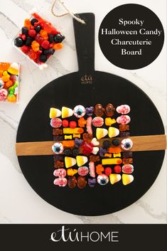 a black board with candy on it and the words spooky halloween candy charine board