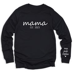 👩💕 Celebrate your journey as a mom with our Mama Est Since T-Shirt personalized with your kid's names! 🌟 Customize it for a special touch! 😍 Get yours now and wear your mom pride in style! For different Mother's Day t-shirt designs, please take a look at our Mother's Day collection. https://www.greatwoodboutique.com/collections/mothers-day-tee-shirts Crew Neck Tops With Letter Print For Family Events, Black T-shirt With Name Print For Family Events, Family Matching Custom Text T-shirt For Personalized Gift, Family Matching T-shirt With Custom Text For Personalized Gift, Personalized Family Matching T-shirt With Custom Text, Custom Text Family Matching T-shirt For Personalized Gift, Personalized Tops For Mother's Day, Mother's Day Custom Print Tops For Family Events, Family Matching Long Sleeve Custom Print T-shirt