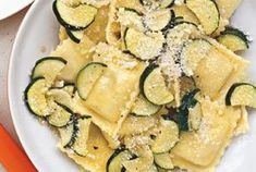 pasta with zucchini and parmesan cheese in a white bowl