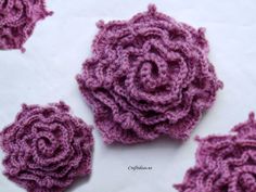 three crocheted flowers on top of each other