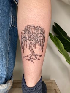 a person with a tree tattoo on their leg