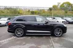 an audi suv parked in a parking lot