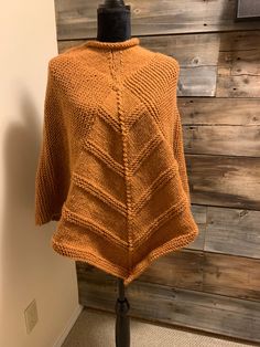 This lovely lady's poncho is fashionably light weight. It is perfect for work or a night out, cool spring days and summer nights around the campfire. A beautiful light-colour burnt orange yarn make it the perfect find.  It is made with a blended yarn and can be washed in cold water (lay flat to dry).  It measures 26 inches from neck to wrist. Knit Fabrication Poncho For Fall, One Size, Knit Fabrication One-size Poncho For Fall, One Size Knit Poncho For Fall, Acrylic Poncho Shawl For Fall, Acrylic Shawl Poncho For Fall, Winter Poncho Cape In Knit, Winter Knit Poncho Cape, Winter Knit Cape Poncho, One Size Soft Knit Poncho For Fall