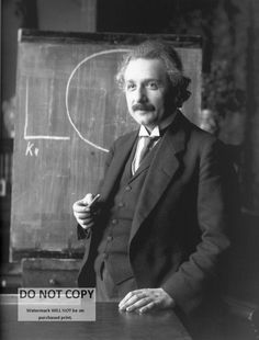 an old photo of a man standing in front of a blackboard