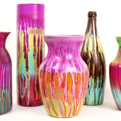 several different colored vases are lined up together