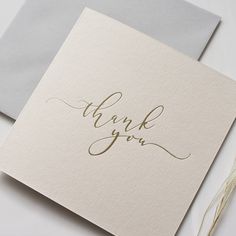 a thank you card with gold foil lettering on it and an envelope that says, thank you