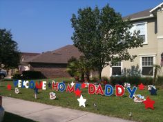 a yard decorated with lawn decorations for a father's day party in front of a house