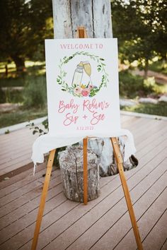 a welcome sign for a baby's first birthday is displayed on an easel