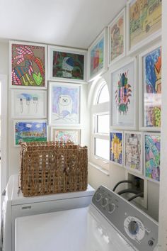 a laundry room with pictures on the wall