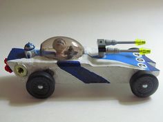 a toy race car with an astronaut in the back