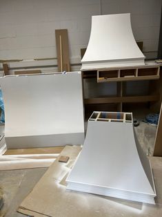 a lamp shade sitting on top of a table next to plywood and other materials