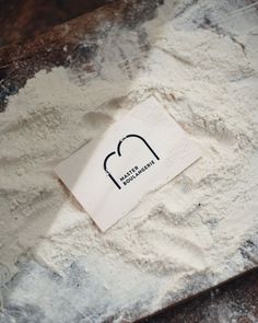 a piece of paper sitting on top of a pile of white powder