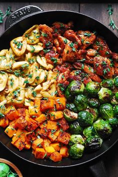 a pan filled with different types of vegetables and meats on top of each other