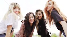 four young women are posing for the camera