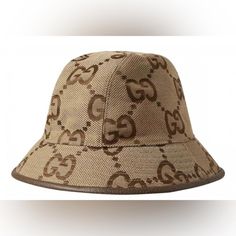 Brand: Gucci Condition: Brand New With Tags And Dust Bag. 100% Authentic Size: Small Behind Every Logo Lies The Tradition And Value Of The House, An Everlasting Medium One Can Wear Again And Again. Here The Jumbo Gg Canvas Defines This Camel And Ebony Bucket Hat. A Brown Leather Trim Completes The Style. Camel And Ebony Jumbo Gg Canvas Brown Leather Trim Cotton And Linen Lining Made In Italy 70% Cotton 30% Polyester; Lining: 65% Cotton 35% Linen; Interior: 55% Cotton 45% Viscose; Details: 100% C Gucci Bucket Hats, Supreme Bucket Hat, Gucci Bucket Hat, Designer Bucket Hats, Bucket Hat Style, Canvas Hat, Mens Bucket Hats, Gucci Hat, Cloche Hat