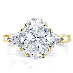 an oval cut diamond ring with three pear shaped diamonds