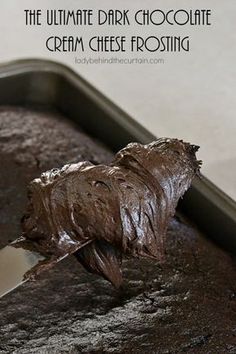 the chocolate cake has been frosted and is ready to be cut into pieces with a knife