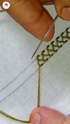 someone is doing something with some scissors and thread