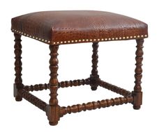 a brown leather stool with wooden legs and studding on the backrest, against a white background